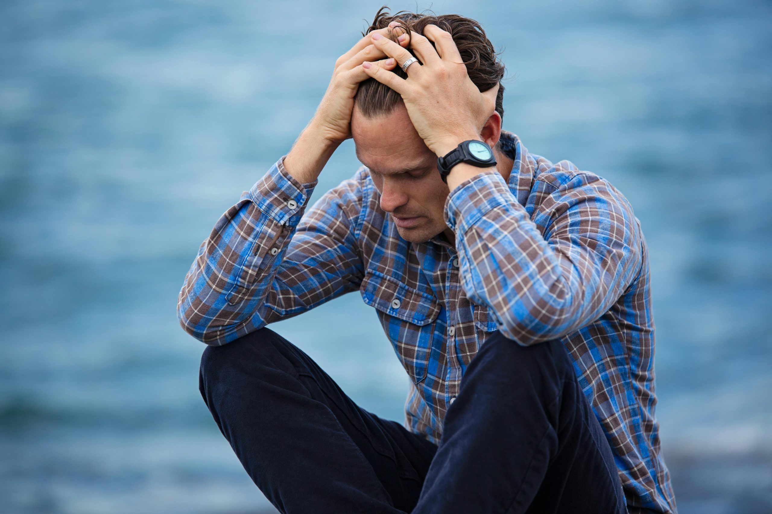 Photo by Nathan Cowley:<br />
Man in Blue and Brown Plaid Dress Shirt Touching His Hair